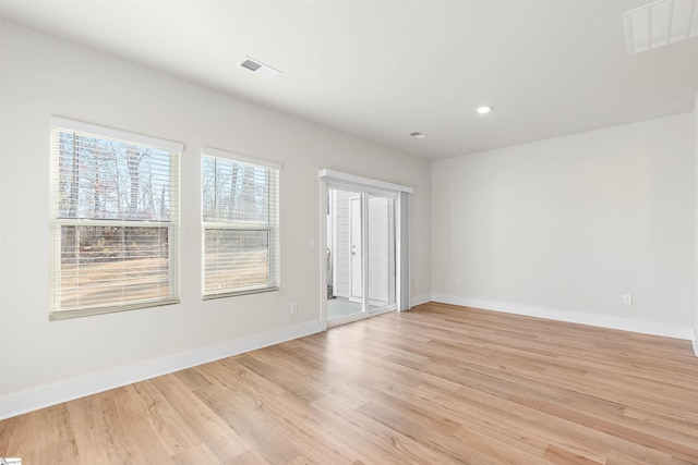 empty room with light hardwood / wood-style flooring