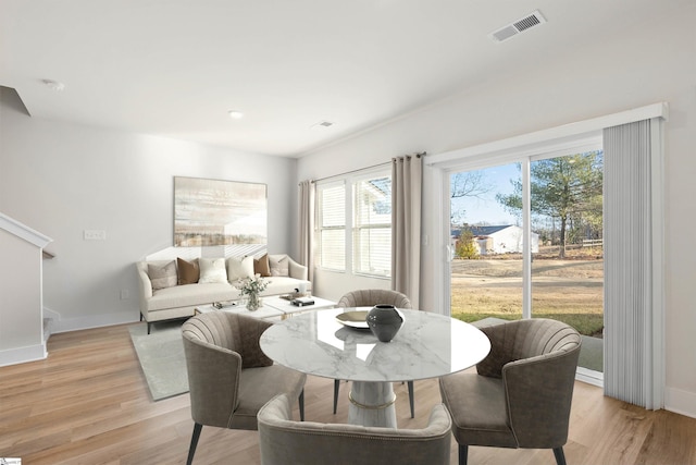 dining space with light hardwood / wood-style floors