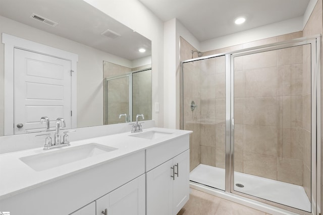 bathroom featuring an enclosed shower, tile patterned floors, and vanity