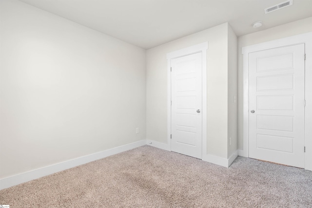 unfurnished bedroom featuring a closet and carpet