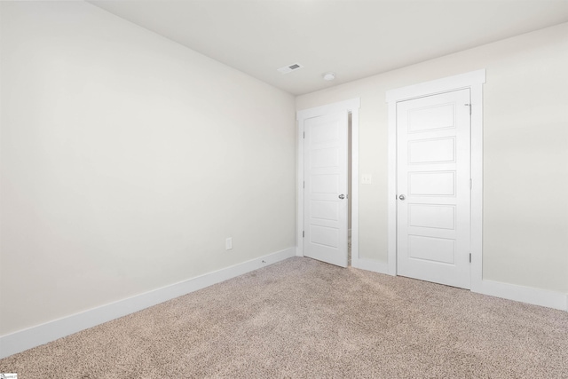 unfurnished bedroom with a closet and carpet