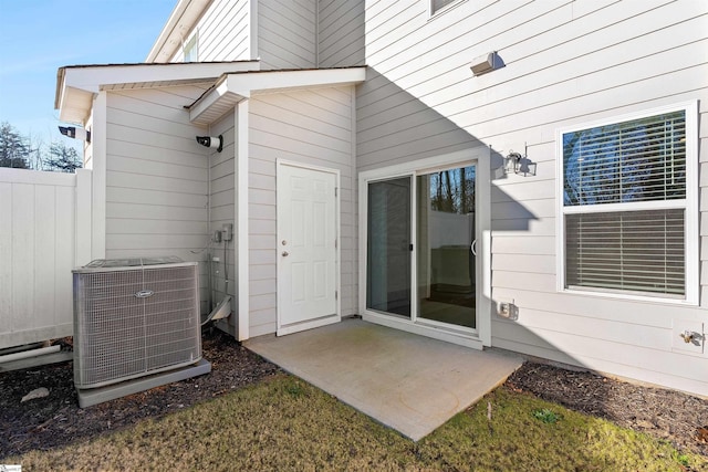 entrance to property with a patio and central AC unit