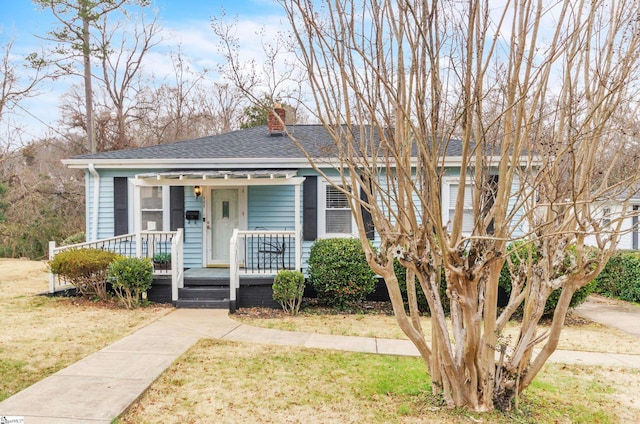 bungalow-style home featuring a porch and a front lawn