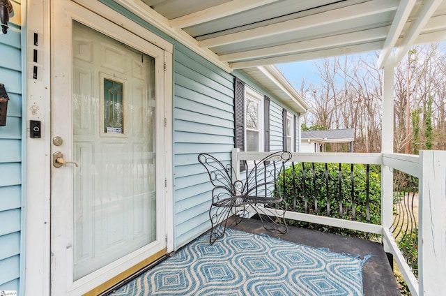 view of exterior entry with covered porch