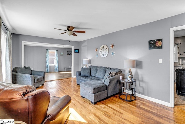 living room featuring ceiling fan and hardwood / wood-style flooring