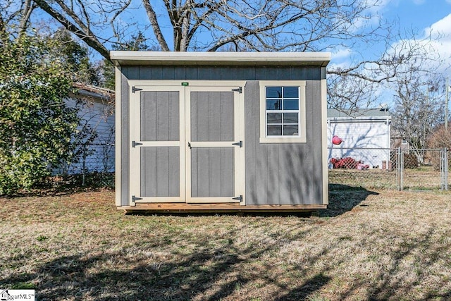 view of outbuilding with a yard