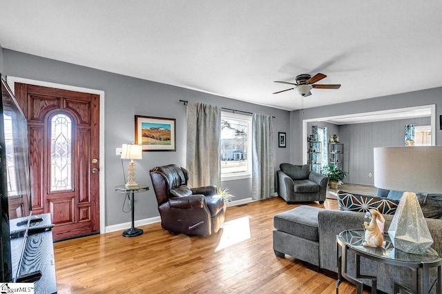 living room featuring ceiling fan and light hardwood / wood-style flooring