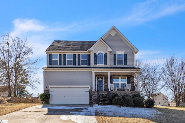 view of front of home featuring a porch and a garage