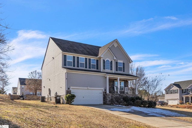 view of front of property with a porch, a front yard, central AC unit, and a garage