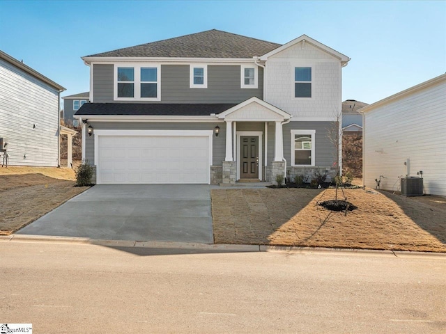 view of front of property featuring central AC and a garage