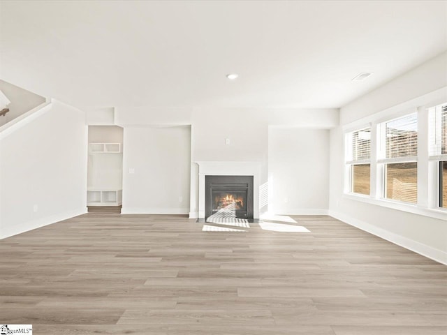 unfurnished living room featuring light hardwood / wood-style flooring