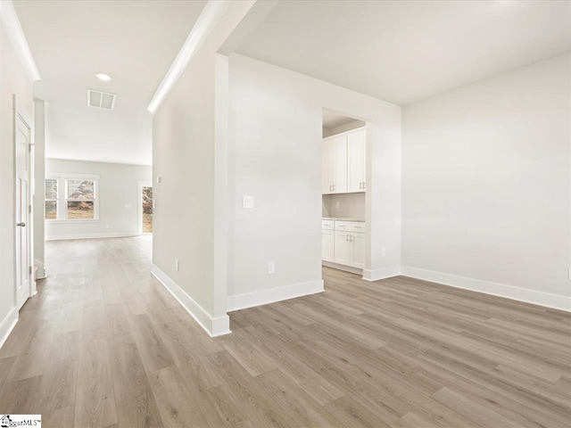 hallway with light hardwood / wood-style flooring