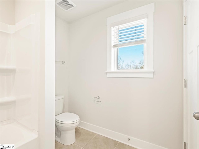 bathroom with toilet and tile patterned floors