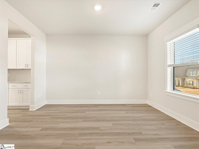 spare room featuring light wood-type flooring