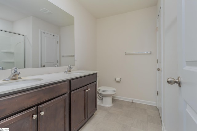 bathroom featuring toilet, a shower, and vanity