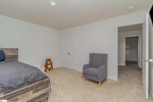 bedroom featuring a closet and light carpet