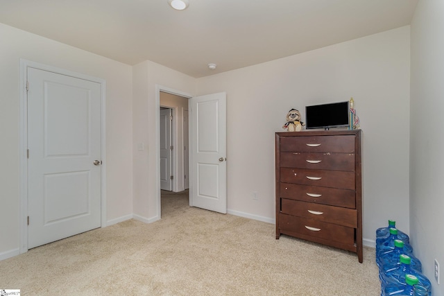 bedroom featuring light colored carpet