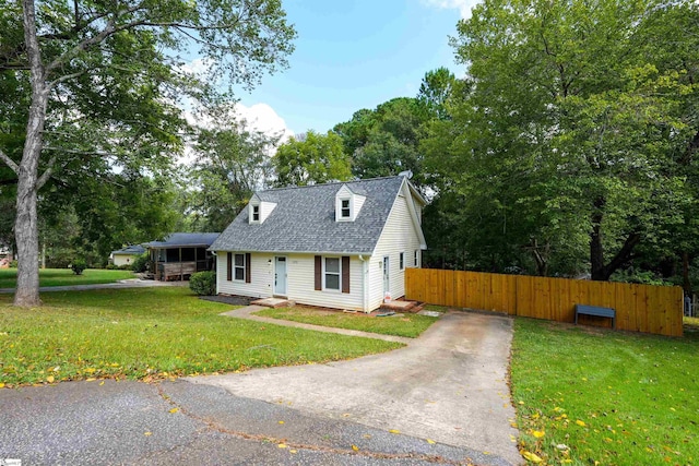 cape cod home with a front yard