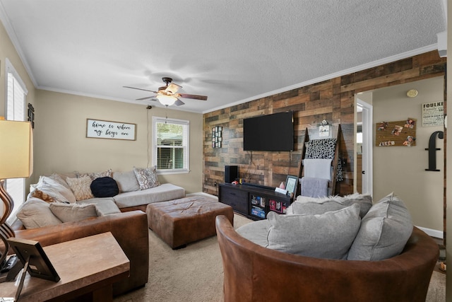 carpeted living room with ceiling fan, wood walls, and ornamental molding