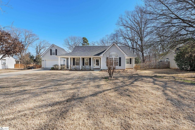 ranch-style home with a porch, a front yard, and a garage