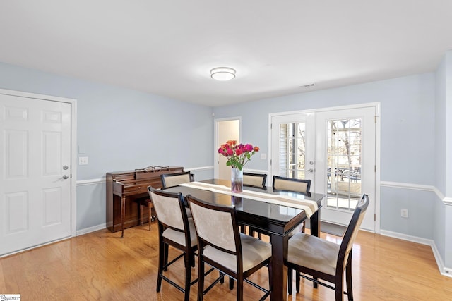 dining area with light hardwood / wood-style flooring