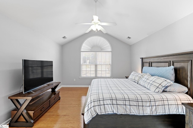 bedroom featuring ceiling fan, light hardwood / wood-style floors, and lofted ceiling