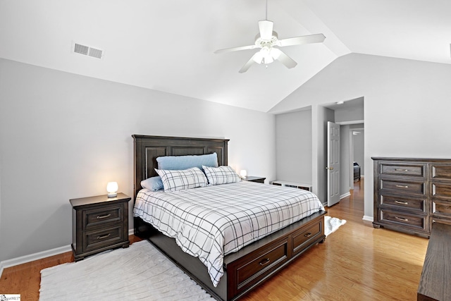 bedroom featuring ceiling fan, light hardwood / wood-style floors, and vaulted ceiling