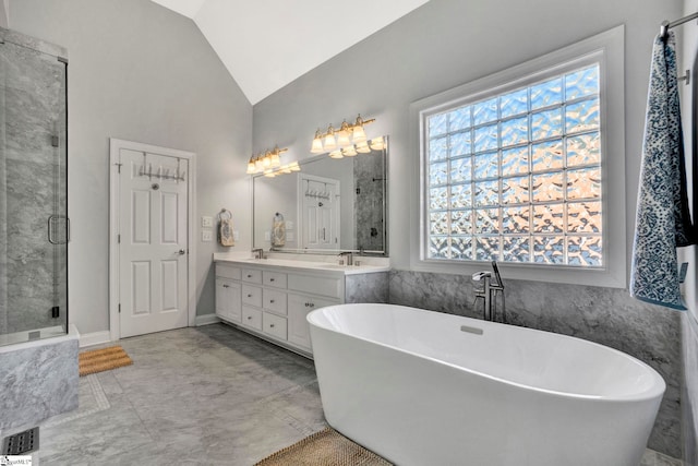 bathroom with shower with separate bathtub, vanity, and vaulted ceiling