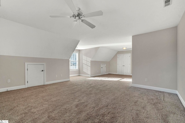 bonus room with vaulted ceiling, ceiling fan, and carpet