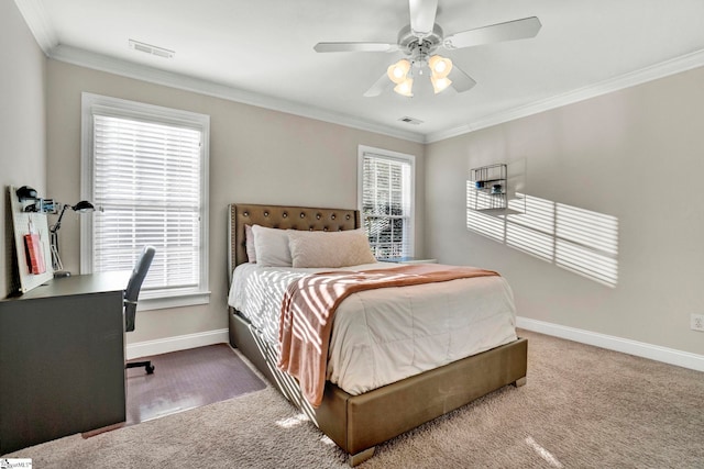 carpeted bedroom featuring ceiling fan and crown molding