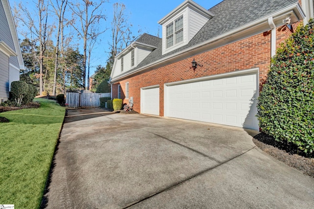 view of property exterior with a lawn and a garage