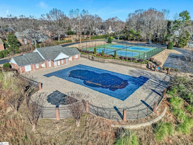 view of swimming pool with tennis court