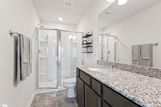 bathroom featuring toilet, walk in shower, and vanity