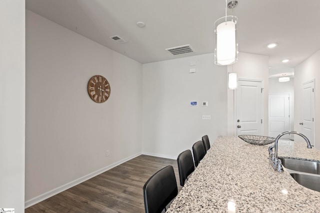 dining space with sink and dark hardwood / wood-style flooring