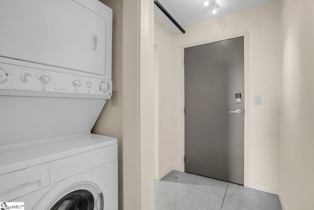 laundry area featuring stacked washer and dryer