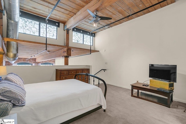 bedroom with beamed ceiling, carpet flooring, ceiling fan, and wood ceiling