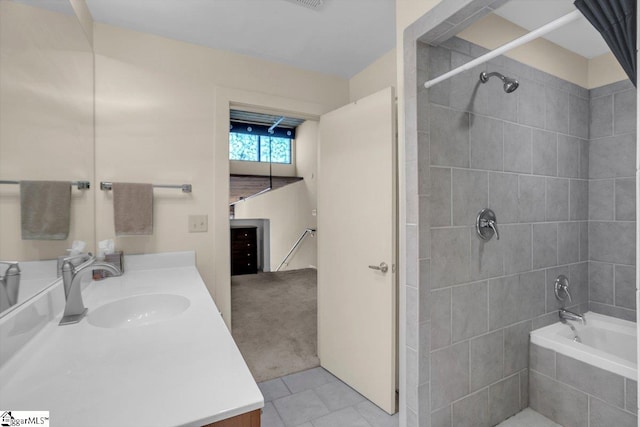 bathroom featuring vanity, tile patterned flooring, and tiled shower / bath combo