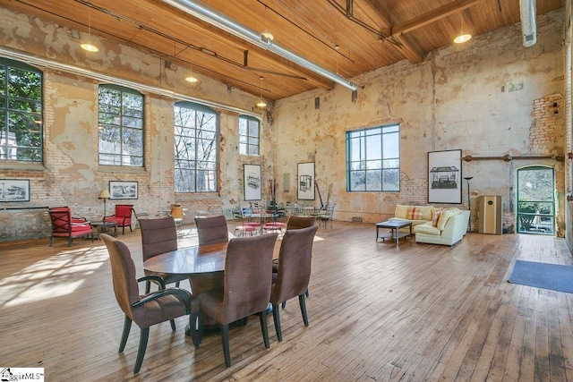 dining room with a high ceiling, wood ceiling, and beam ceiling