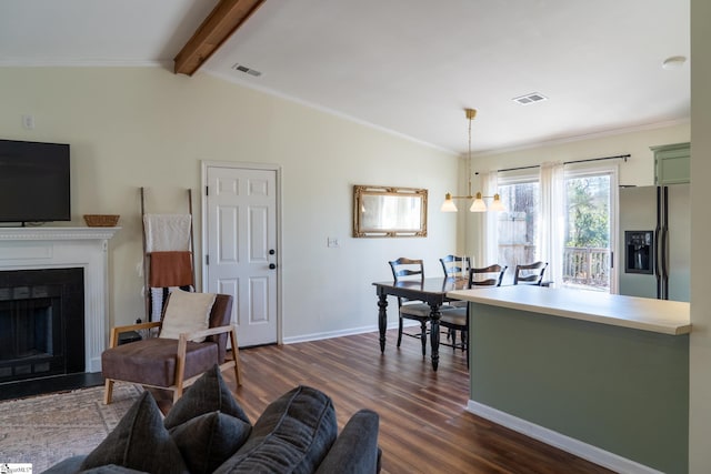 living room featuring dark wood-type flooring, a notable chandelier, crown molding, and vaulted ceiling with beams