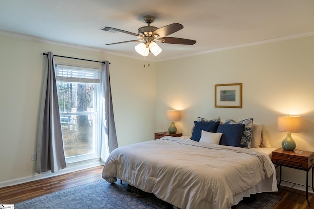 bedroom featuring dark wood-type flooring, ceiling fan, and crown molding