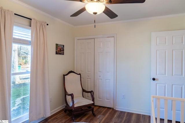 bedroom featuring dark wood-type flooring, ceiling fan, a closet, and ornamental molding