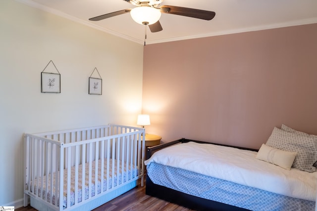 bedroom with ornamental molding, ceiling fan, and hardwood / wood-style floors