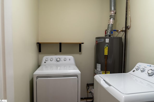 laundry area featuring water heater and washing machine and clothes dryer