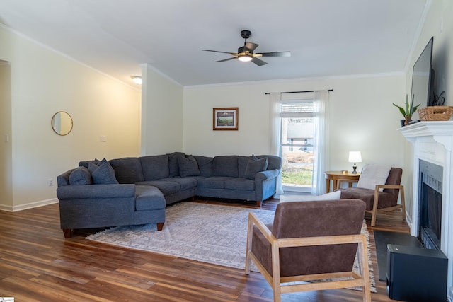 living room featuring ceiling fan, crown molding, and dark hardwood / wood-style floors