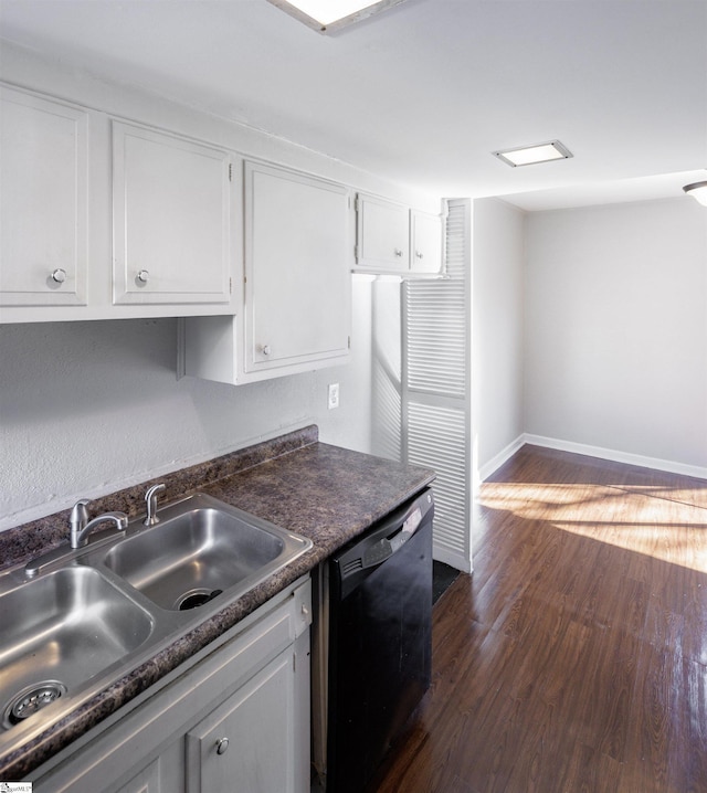 kitchen featuring sink, dark wood-type flooring, black dishwasher, and white cabinetry