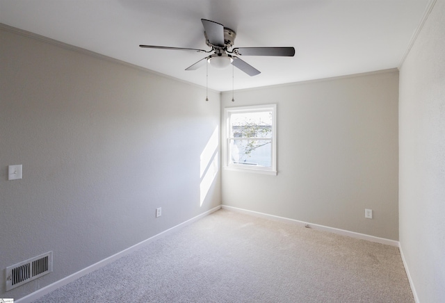 carpeted spare room featuring ceiling fan and ornamental molding