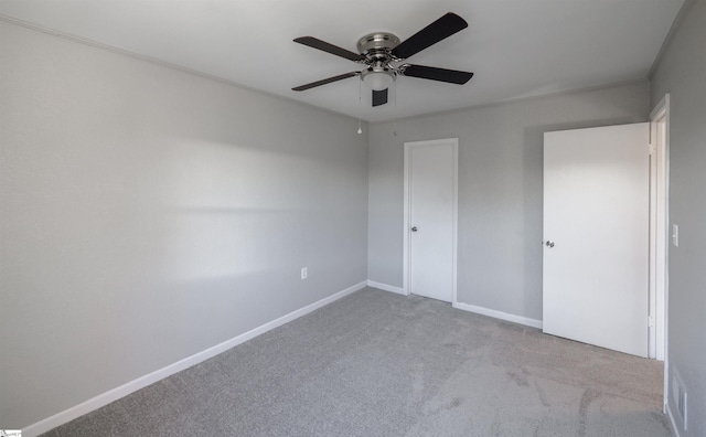 unfurnished bedroom with ceiling fan and light carpet