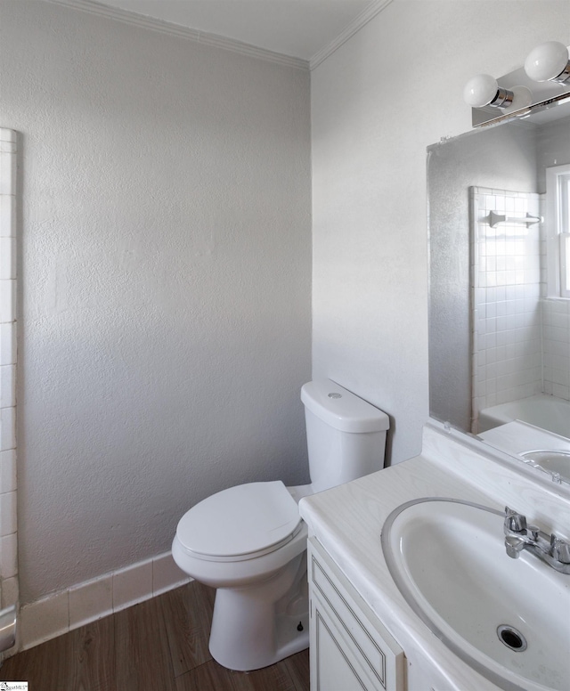 bathroom featuring ornamental molding, toilet, vanity, and hardwood / wood-style flooring