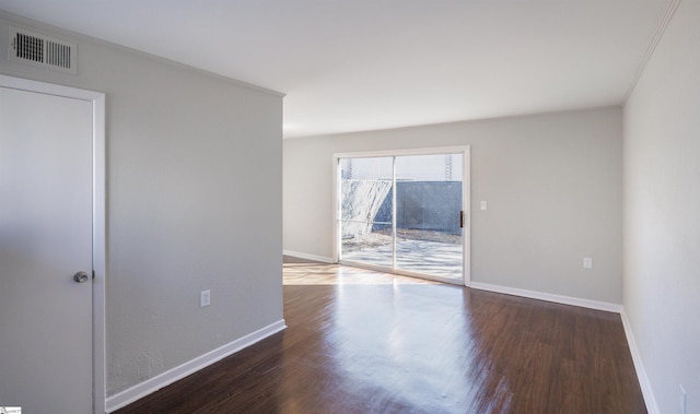 unfurnished room with dark wood-type flooring and ornamental molding