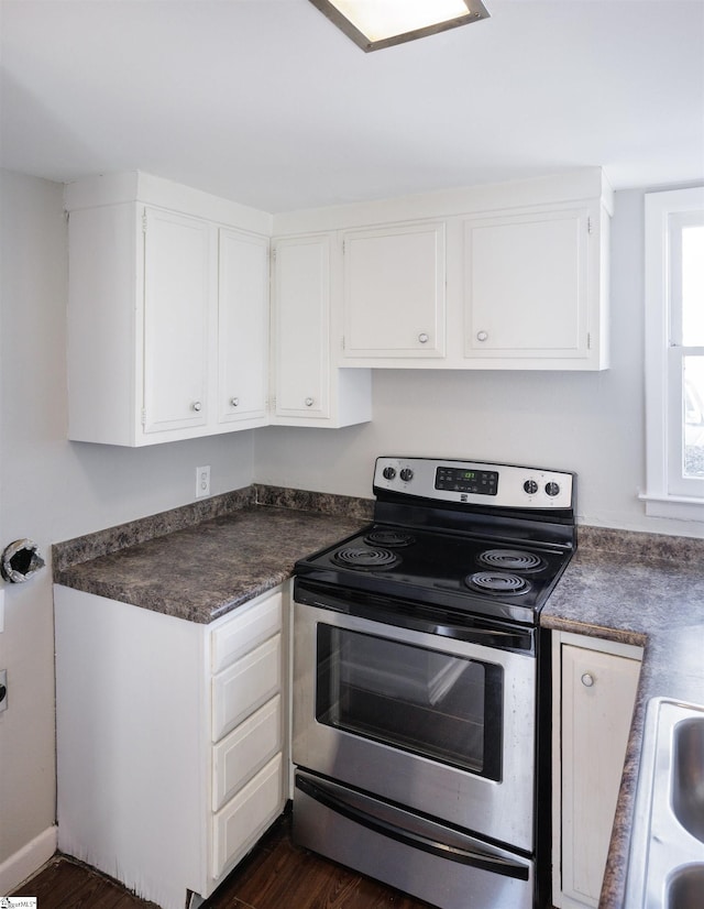 kitchen with stainless steel range with electric stovetop, white cabinetry, and dark hardwood / wood-style floors